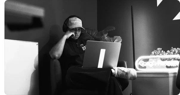 A Setsail team member working on a laptop in the studio, in black and white
