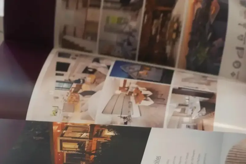 Printed brand pages fanned across a table