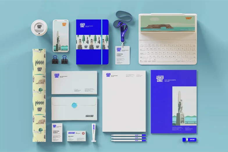 Choose Santa Cruz stationery, signage and merchandise laid out on blue