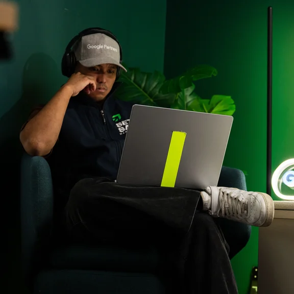 A Setsail performance marketing lead at his laptop in the studio
