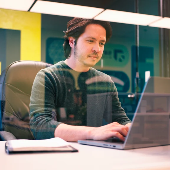 A Setsail email and retention strategist working at his laptop