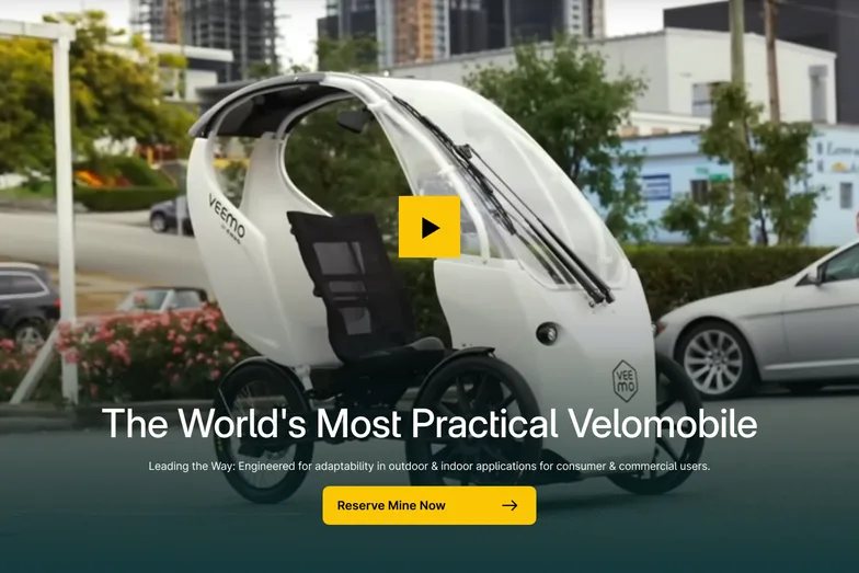 Envo’s white velomobile on a street, “The World’s Most Practical Velomobile”