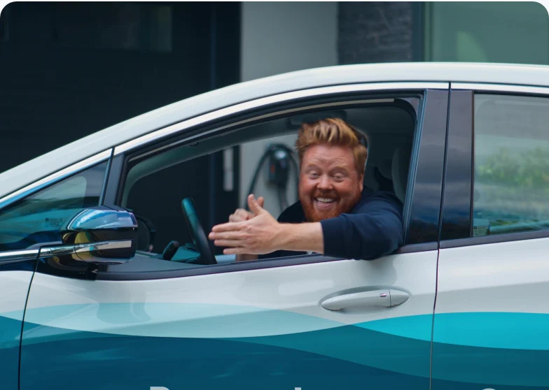 A Setsail client grinning out of his car window