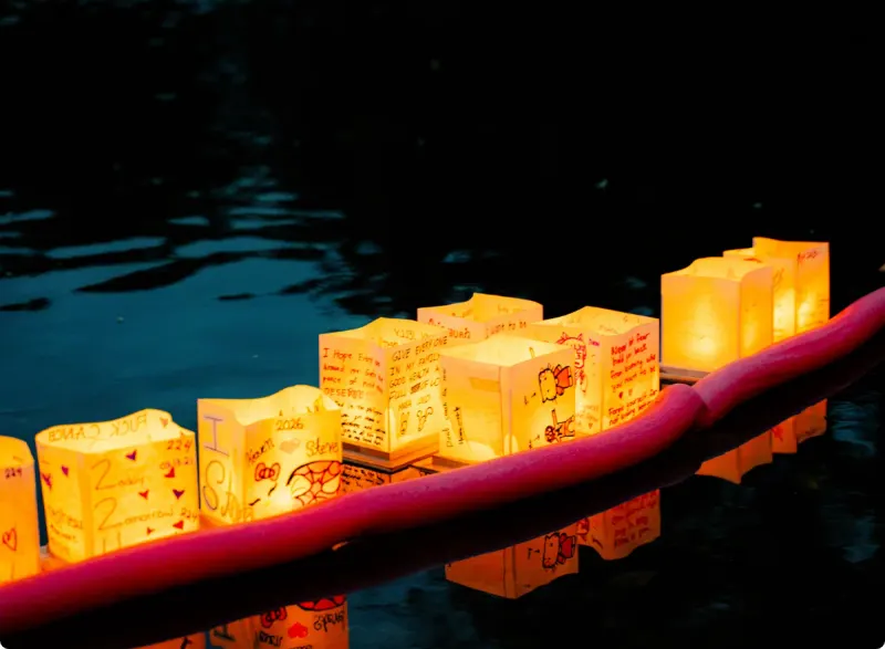 Paper lanterns glowing on dark water at Coquitlam's Water Lantern Festival