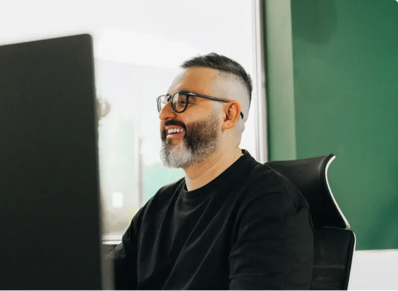 A Setsail Marketing strategist smiling at his desk