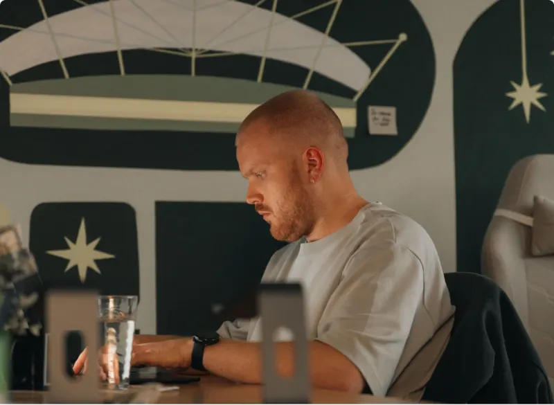 A Setsail Marketing specialist focused on his laptop in the studio