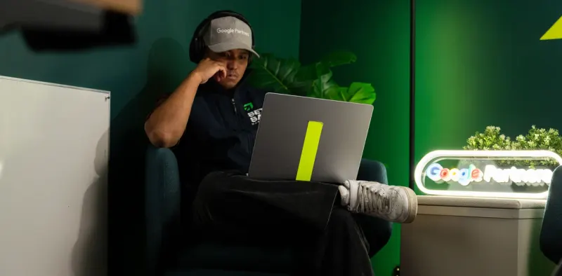 A Setsail specialist working on a laptop by a Google Partners sign