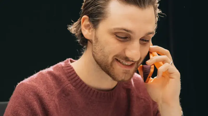 A Setsail Marketing team member smiling on a phone call