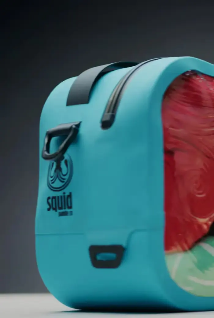 Squid teal submersible bag with logo, black handle and D-ring, open to show colourful contents