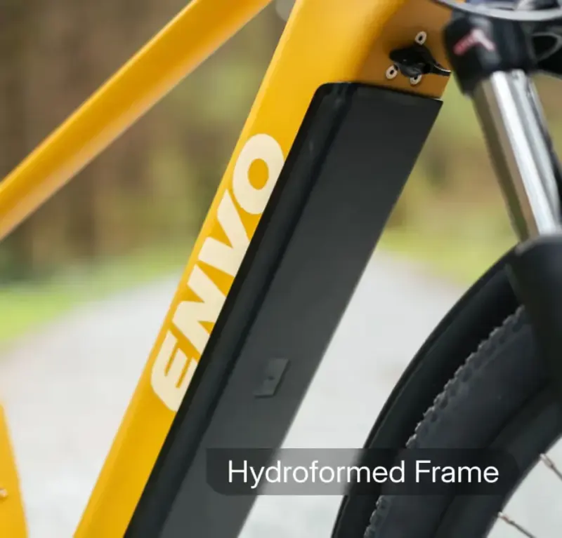 Macro photo of a yellow ENVO e-bike frame and battery with the caption 'Hydroformed Frame'