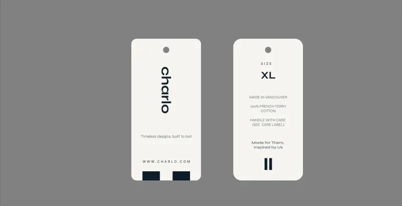 Two Charlo hang tags: the vertical wordmark, and an XL size tag that reads “Made in Vancouver, 100% French terry cotton”