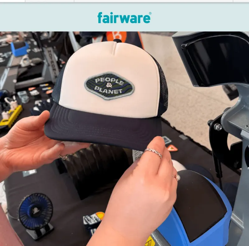 Fairware email “Keepsakes, Not Just Giveaways”, opening on a People and Planet trucker cap being pressed at a live merch station