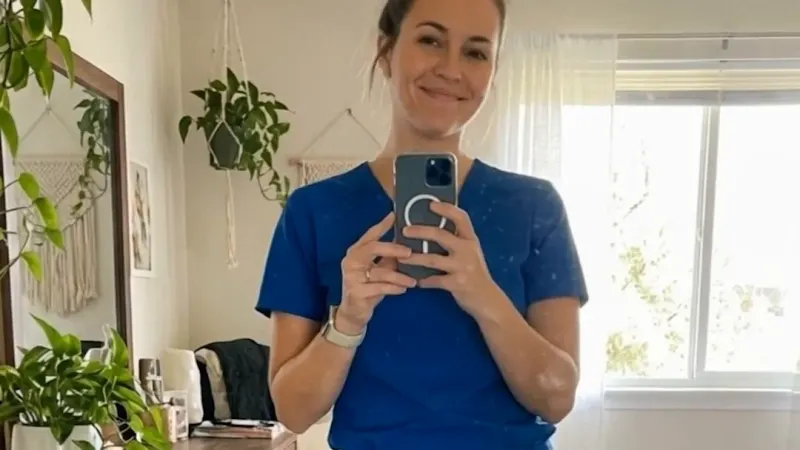 A creator in new blue scrubs taking a mirror selfie, from a UGC-style ad