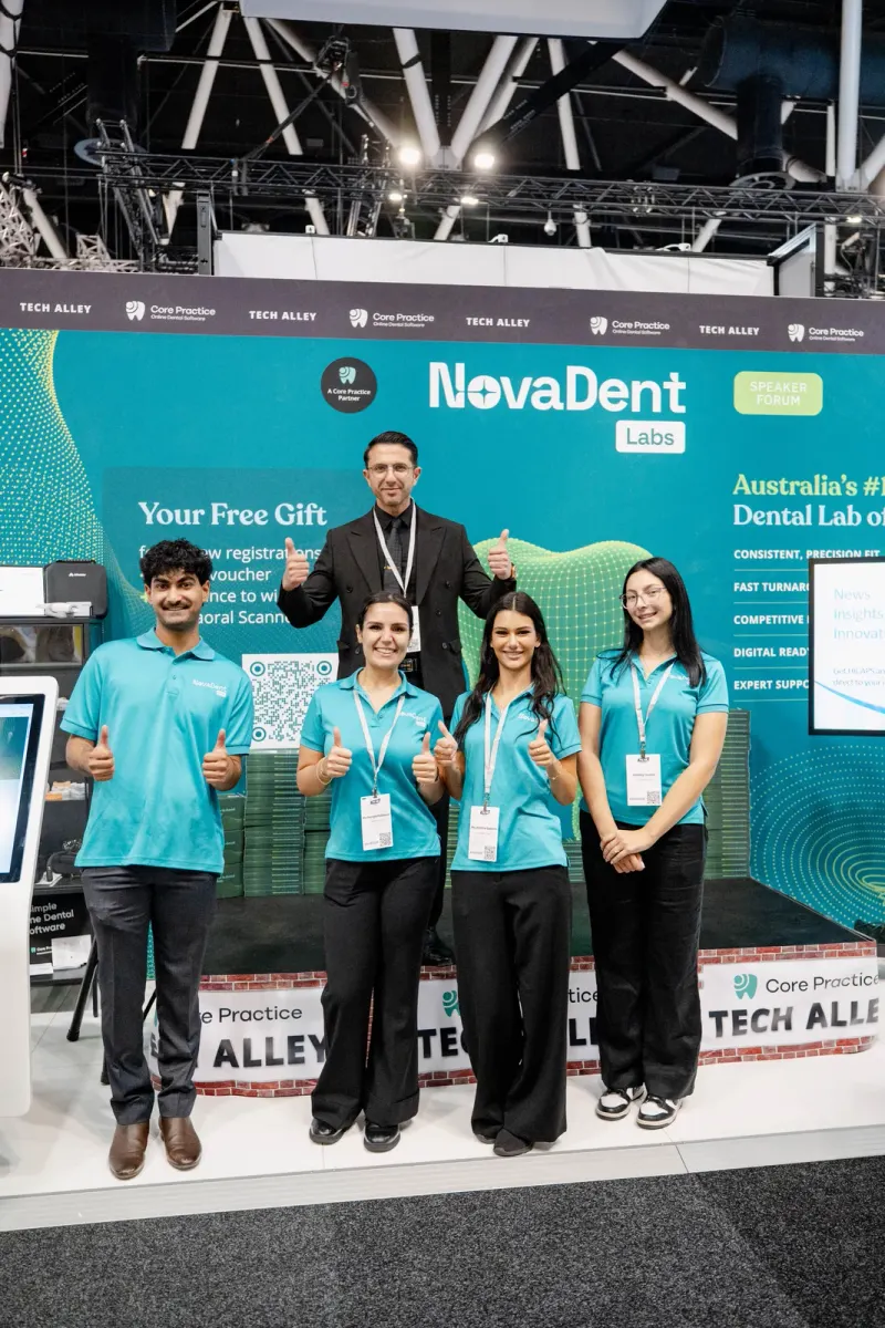 The NovaDent Labs team at its booth, with the sign “Australia’s #1 Dental Lab”