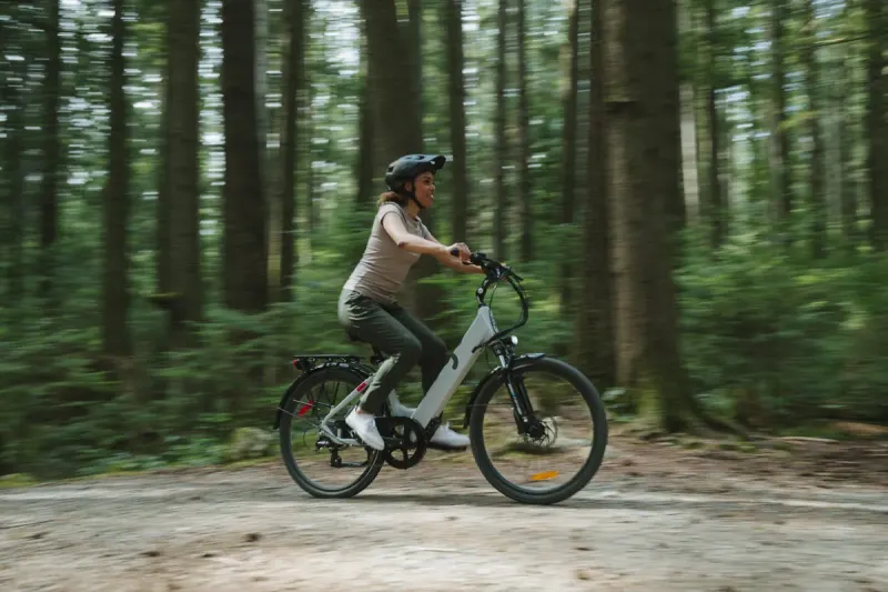 A rider on an EBGO e-bike on a forest trail