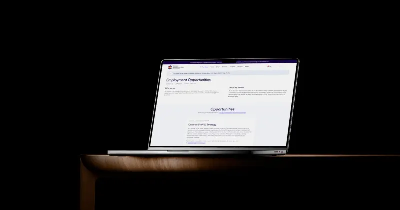 The State of Colorado careers site we built, on a MacBook Pro on a wooden desk