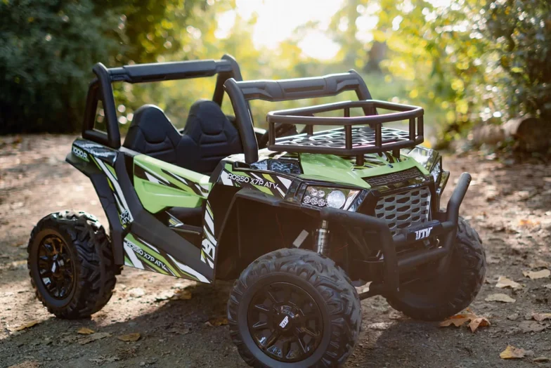 A green ride-on UTV from Rosso Motors on a forest trail