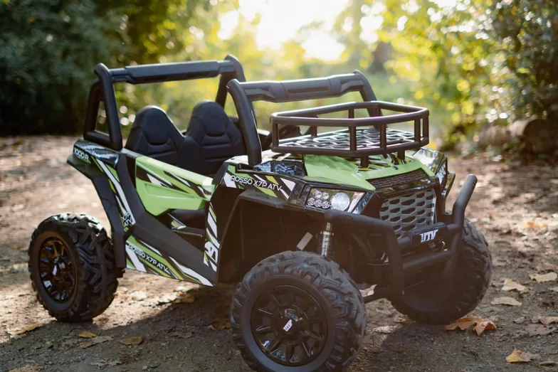 An electric off-road buggy parked on a forest trail