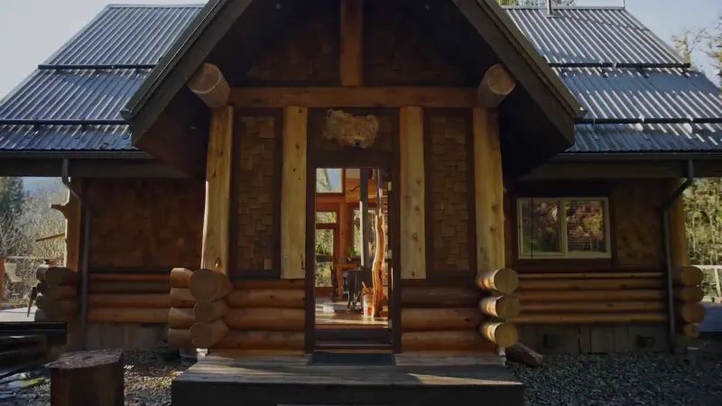 A timber cabin in the woods, from the Adventure House Swap brand film Setsail made