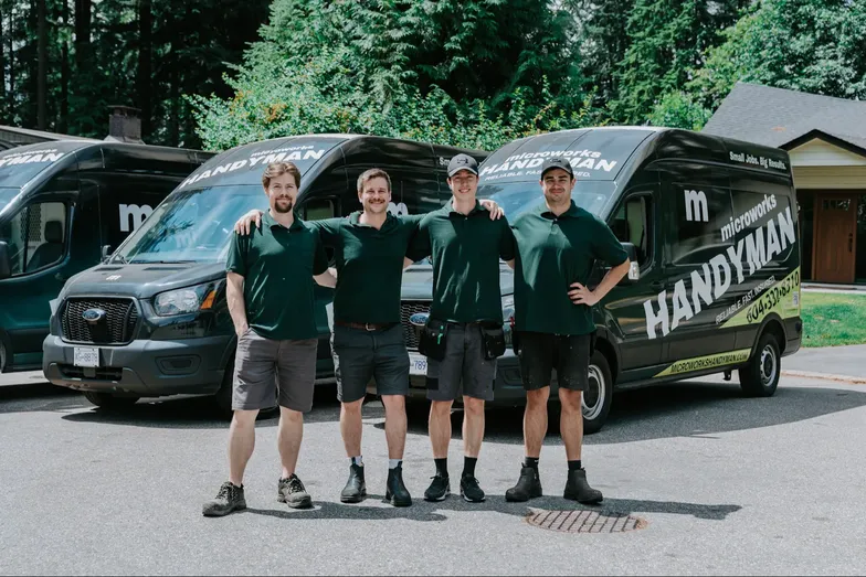 The Microworks Handyman crew in front of their branded vans