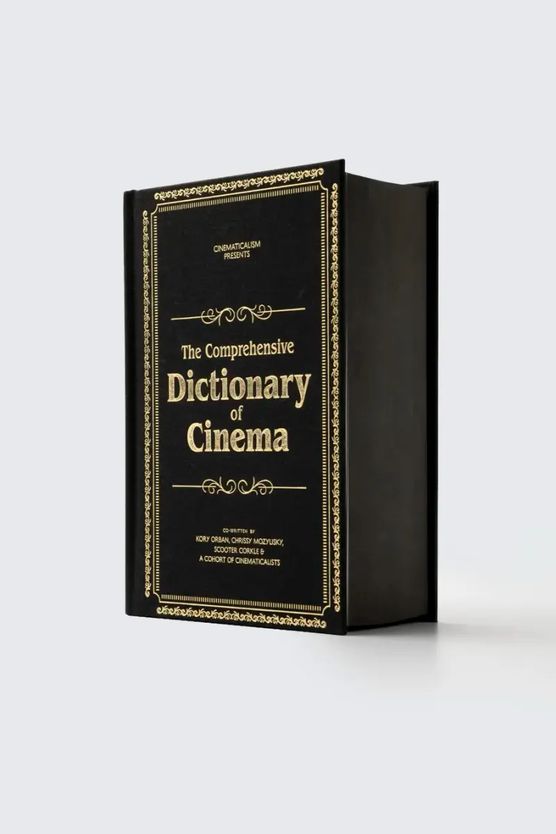 The black and gold edition of the dictionary standing on a grey ground