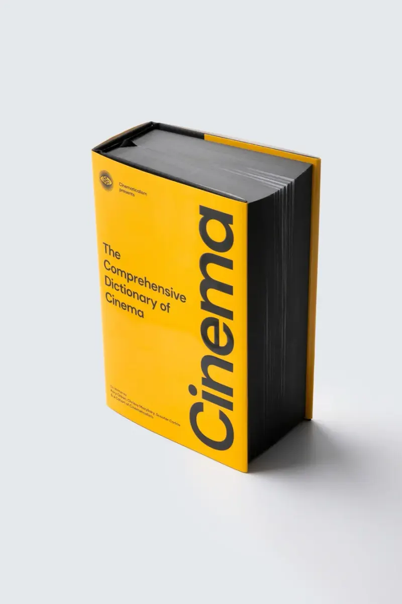 The yellow Cinema edition of the dictionary standing on a grey ground