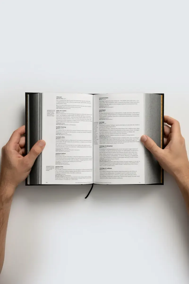 Hands holding the dictionary open, seen from above
