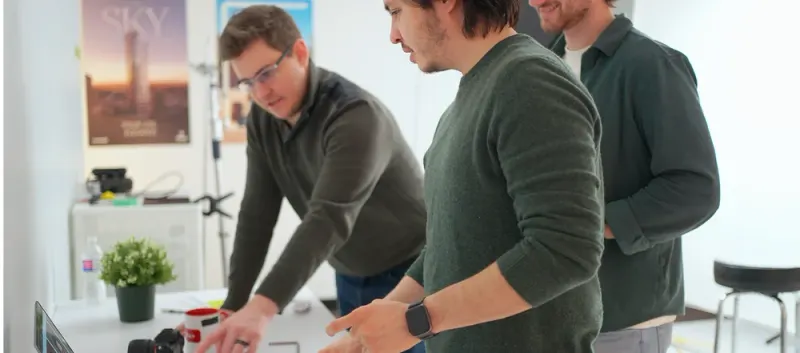 Three Setsail Marketing colleagues working together at a studio table