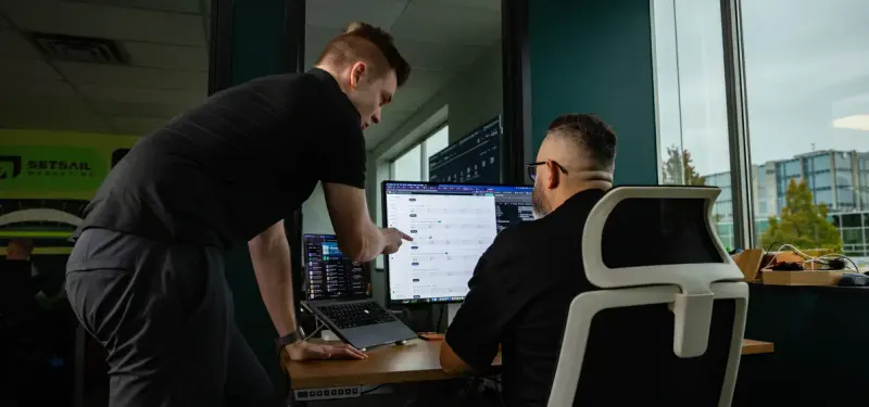 Two Setsail team members reviewing a screen