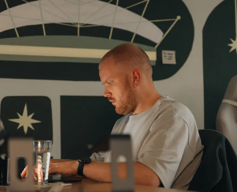 A Setsail team member working at a laptop in the studio