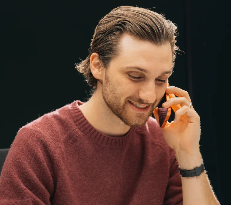 A team member on the phone, smiling