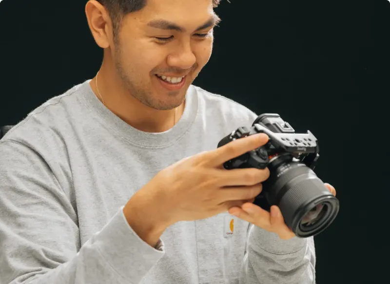 A Setsail photographer smiling as he checks his camera