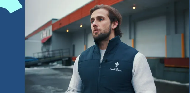 A client in a branded vest outside his warehouse