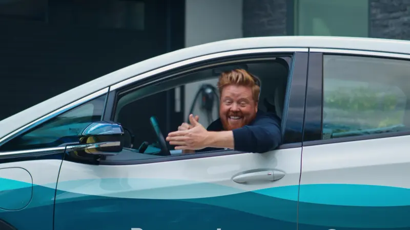 A Google Ads summary beside a smiling driver at a car window: 214K impressions, 8.4K clicks, 3.9% click-through and 312 conversions