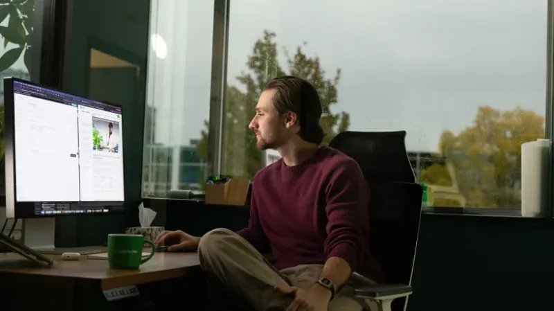 A Setsail team member working at his desk by the window