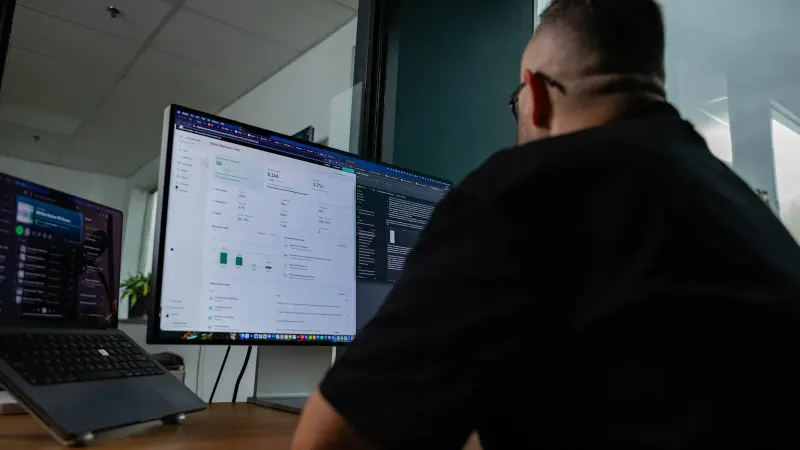 A Setsail strategist reviewing a performance dashboard across two monitors.