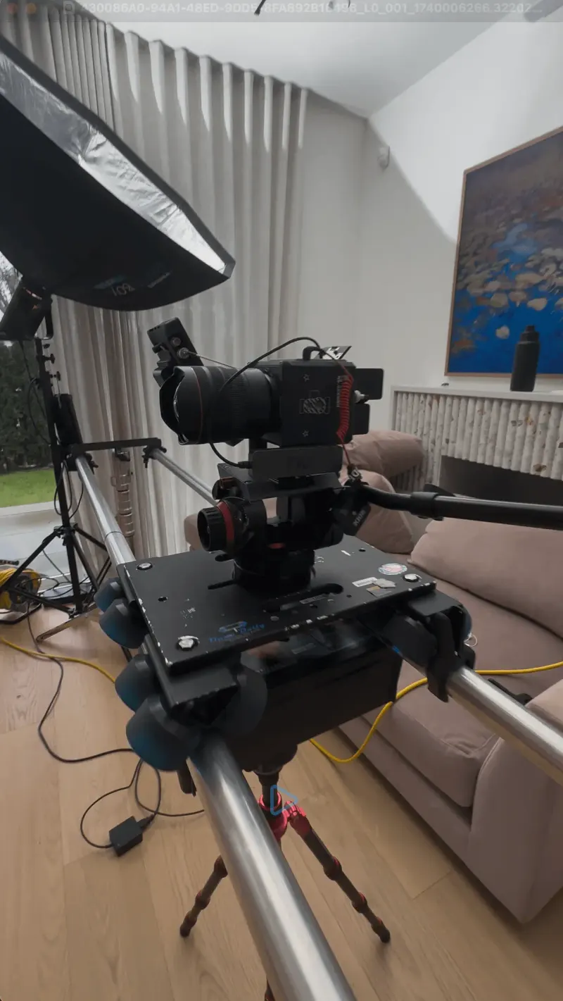 Video camera on a slider rig with a softbox light in a living room set during the BC Hydro shoot
