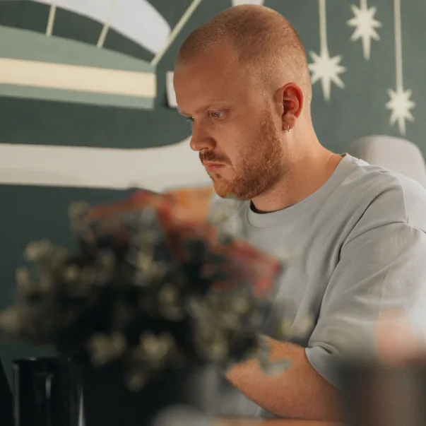 A Setsail Marketing team member concentrating at his computer in the studio