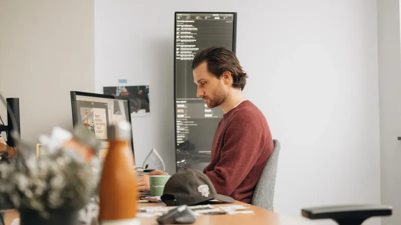A Setsail strategist working at his desk in the office.