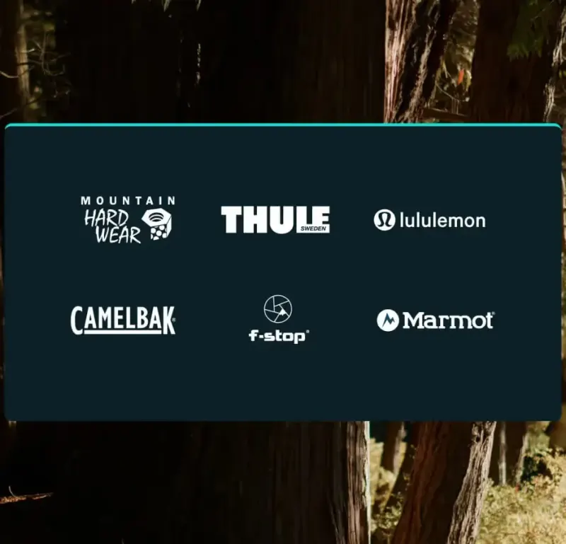Partner logos on a dark panel over a forest: Mountain Hardwear, Thule, lululemon, CamelBak, f-stop and Marmot