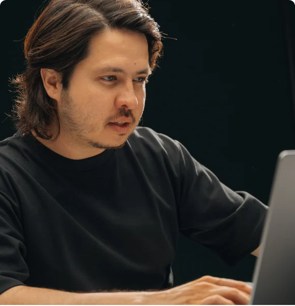 A Setsail team member writing a client page at his desk